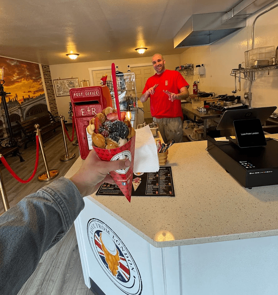 The owner smiling inside the Love From London shop